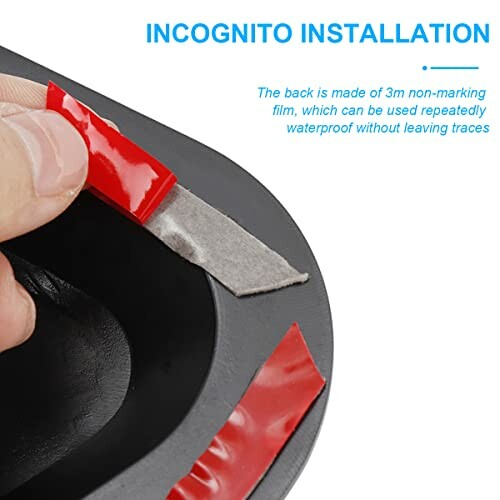 Hand peeling red adhesive strip from black object labeled 'Incognito Installation'.